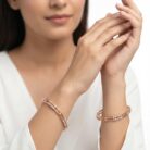 A pair of 18k gold minimalist double-band bangles with stone accents by OVJ Jewels.