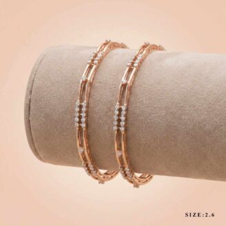 A pair of 18k gold minimalist double-band bangles with stone accents by OVJ Jewels.