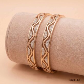 "Pair of 18k gold minimalist bangles featuring a wave cut-out design with small stones, size 2.5, by OVJ Jewels."